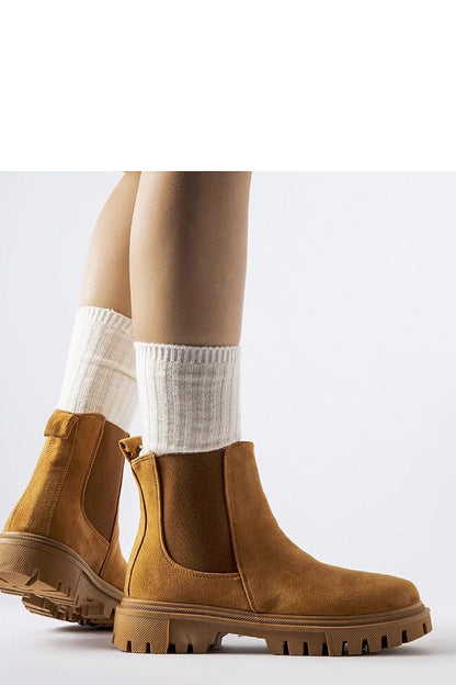 Chic Solea women's slip-on boots in caramel colour, crafted from eco-friendly leather, featuring a comfortable flat heel, ideal for fashion-forward individuals.