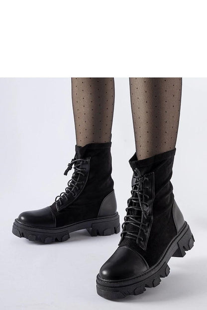 Elegant Solea black vegan leather slip-on boots with stylish lacing Tarces, showcasing their sophisticated design and comfort.