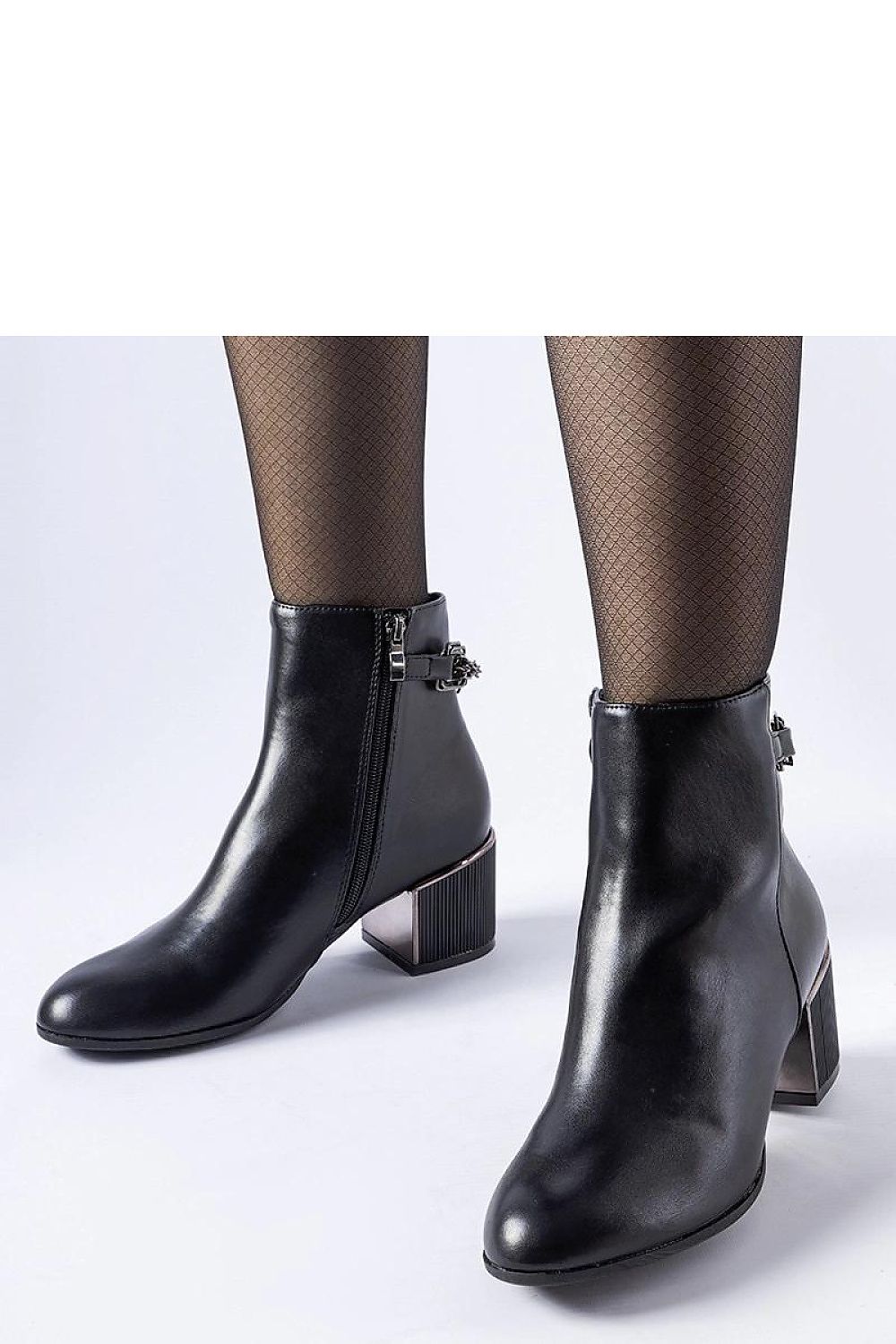 High-quality faux leather Solea ankle boots in black, showcasing modern chain details for chic autumn and winter ensembles.