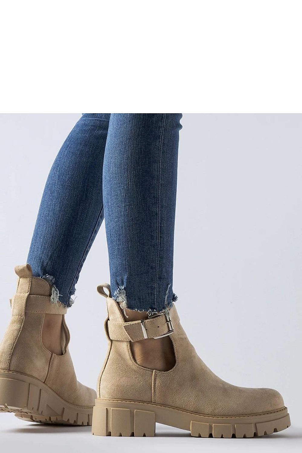 Close-up view of Solea eco-leather ankle boots showcasing the decorative buckle and high ankle cut for stability and protection.