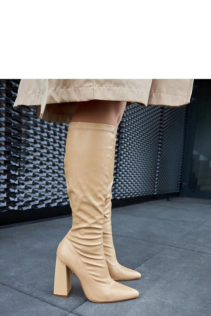 Solea Abelino beige thigh-high column boots displayed against a luxurious backdrop, emphasizing the modern and classic aesthetics.