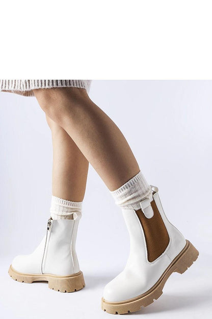 Luxurious Solea white ankle boots featuring a chic beige sole, crafted from eco leather, showcasing stylish side zippers and a round toe, ideal for elegant and casual outfits.