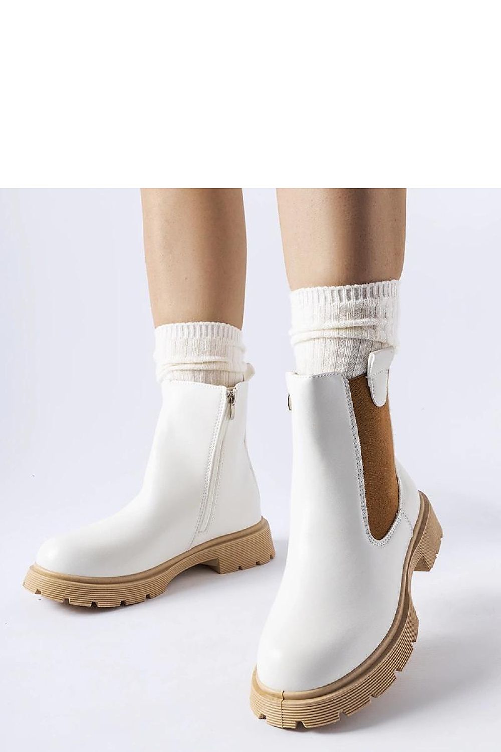 Solea's elegant white ankle boots with a sophisticated beige rubber sole, designed for comfort and style, perfect for autumn-spring wear, embodying femininity and innovation.