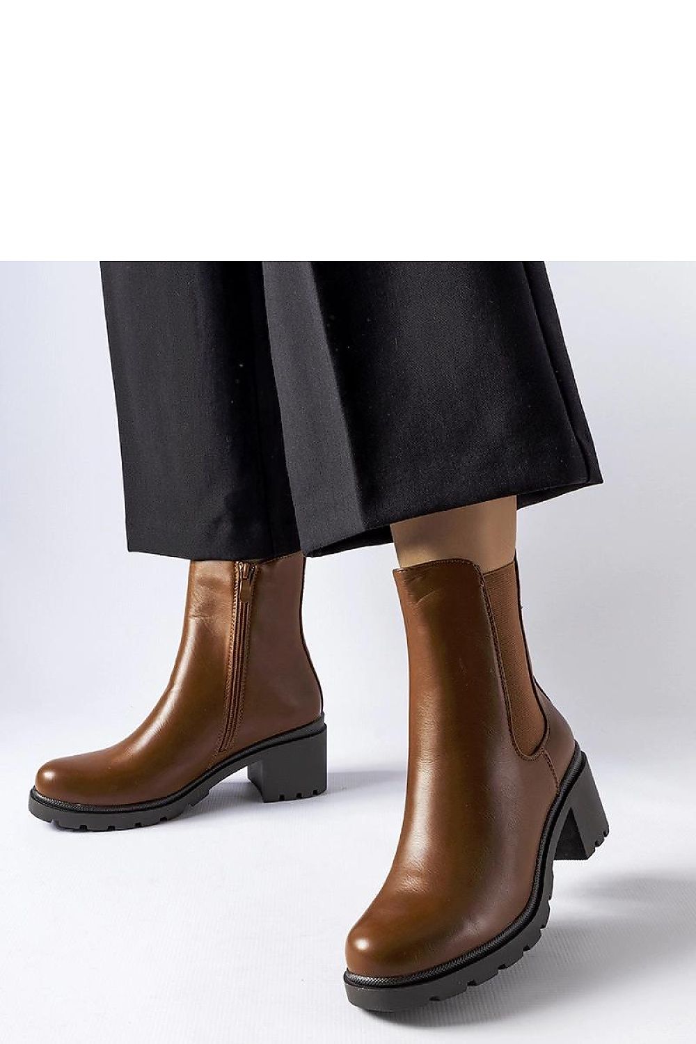 Elegant Solea Classic Brown Carseggio Boots crafted in eco leather, featuring a sophisticated stiletto heel. Perfect for both casual and formal occasions, this stylish footwear enhances leg length with its ankle height design, making it a must-have in every fashionable woman's collection.