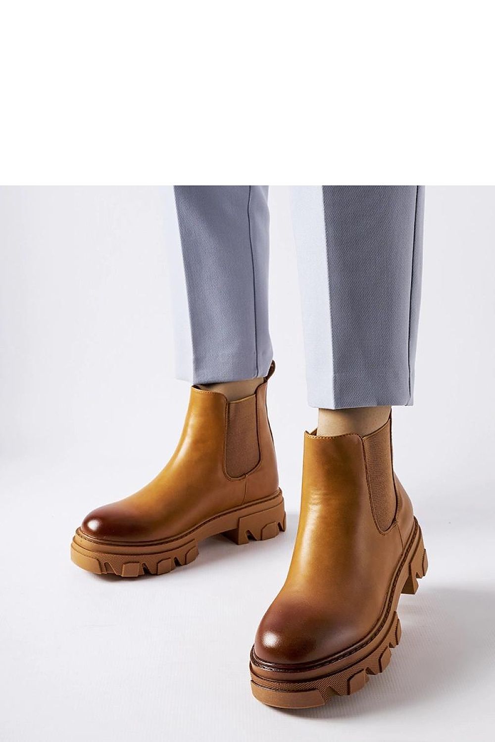 Elegant Solea brown slip-on Castell boots for women crafted from eco leather, featuring a 5 cm heel. Perfect for stylish autumn walks and social gatherings, embodying a blend of modern design and classic charm.