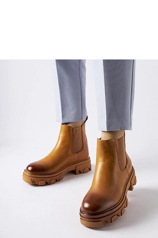 Elegant Solea brown slip-on Castell boots for women crafted from eco leather, featuring a 5 cm heel. Perfect for stylish autumn walks and social gatherings, embodying a blend of modern design and classic charm.