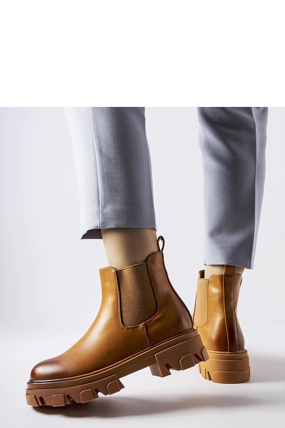 Chic Solea Brown Slip-On Castell Boots for Women featuring a comfortable ankle height and durable rubber sole, embodying luxury and versatility for every occasion.