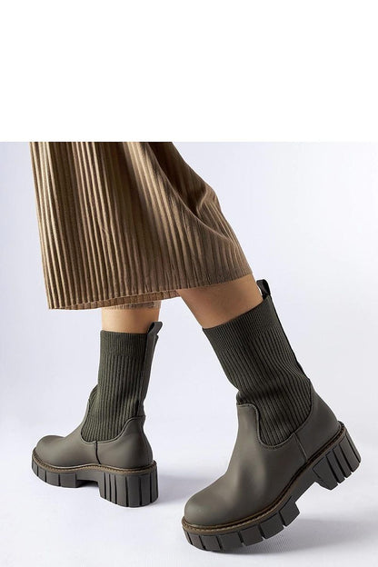 Solea Women's Green Beauchemin Sock Boots elegantly styled with a chic outfit, highlighting their versatility for casual and formal occasions.