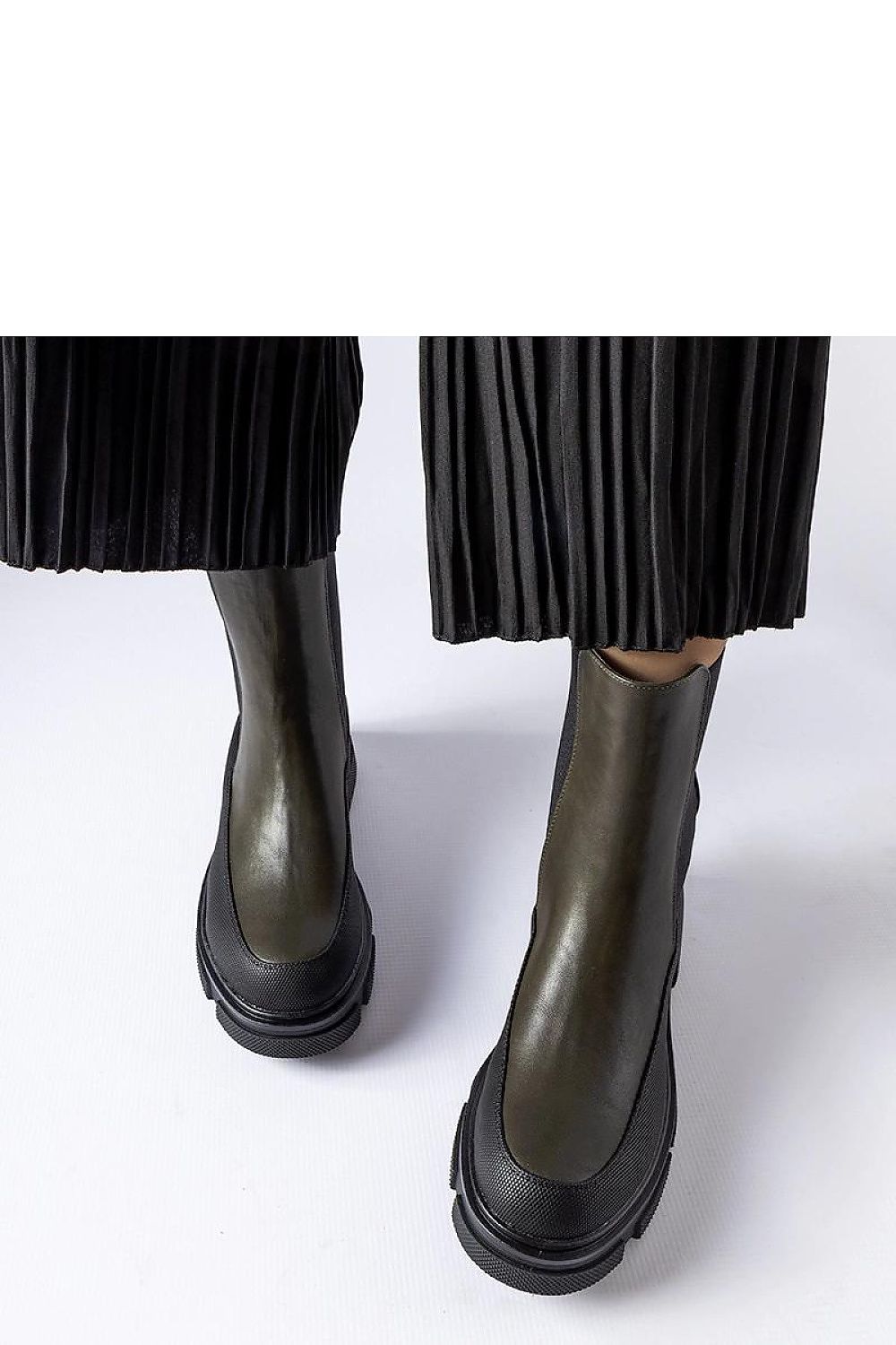 Close-up view of Solea Eco-Friendly Green and Black Faisal Slip-On Boots, featuring chic slip-on closure and high-quality suede leather ideal for fashionable comfort.