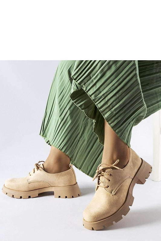 Close-up of Solea beige half boots showcasing their refined design, lace-up closure, and soft eco leather finish, ideal for sophisticated summer outfits.