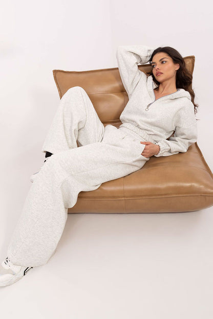 Styling a relaxed look, the Factory Price Women's Tracksuit Set displayed on a model, highlighting its comfort and fashionable appeal.