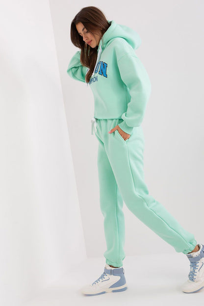 Model wearing Ex Moda casual tracksuit set in a fashionable street setting, embodying modern style and comfort.