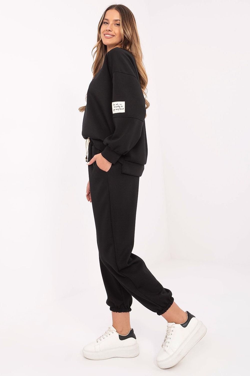 Detail of Italy Moda women's casual tracksuit set, highlighting the high-waisted pants with side pockets and adjustable tie waist in a modern design.