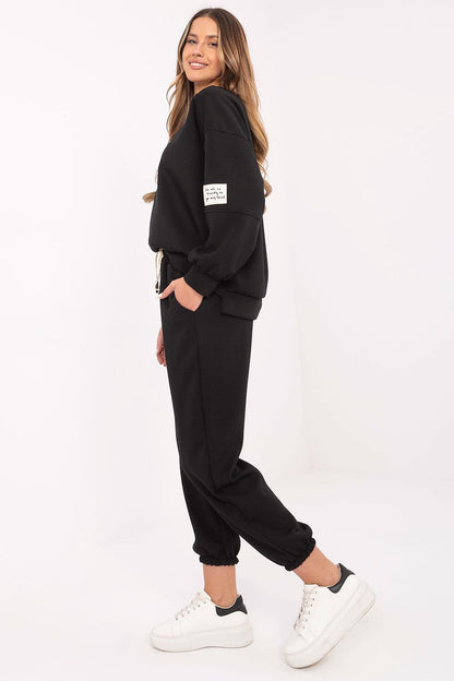 Detail of Italy Moda women's casual tracksuit set, highlighting the high-waisted pants with side pockets and adjustable tie waist in a modern design.