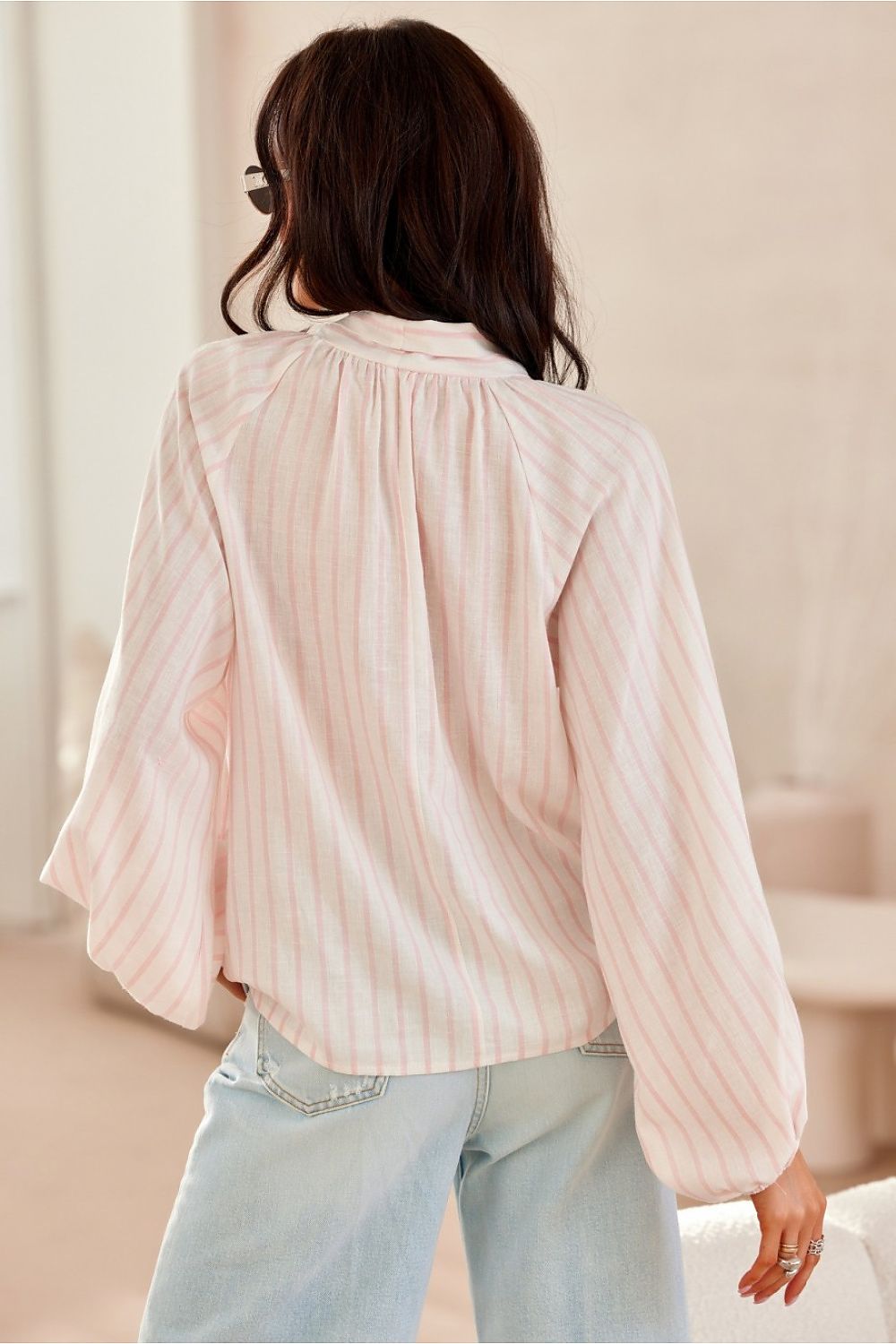 Model wearing Roco Fashion's sophisticated blouse with long puffy sleeves, highlighting its fashionable design suitable for classy casual outings.