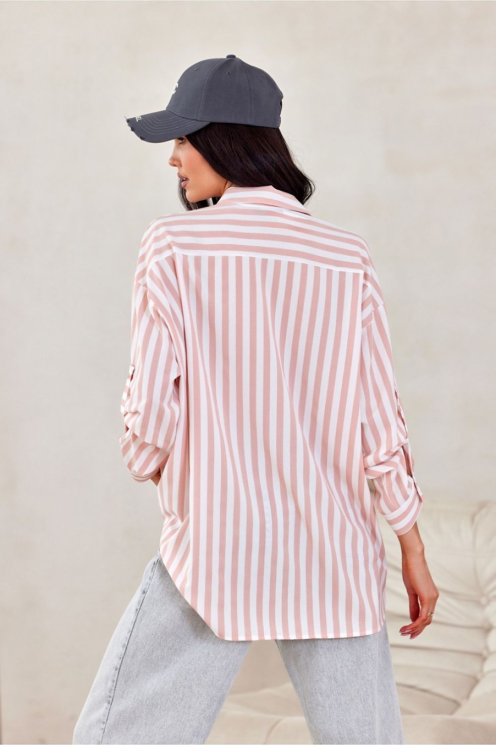 Stylish Roco Fashion oversized long sleeve shirt displayed on a mannequin, highlighting its striking asymmetrical cut and elegant silhouette.