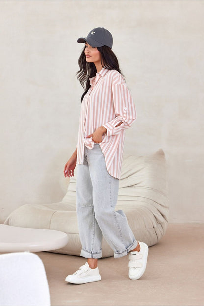 Roco Fashion oversized long sleeve shirt in a chic setting, emphasizing its versatility and luxurious fabric composition, ideal for any fashion-forward wardrobe.