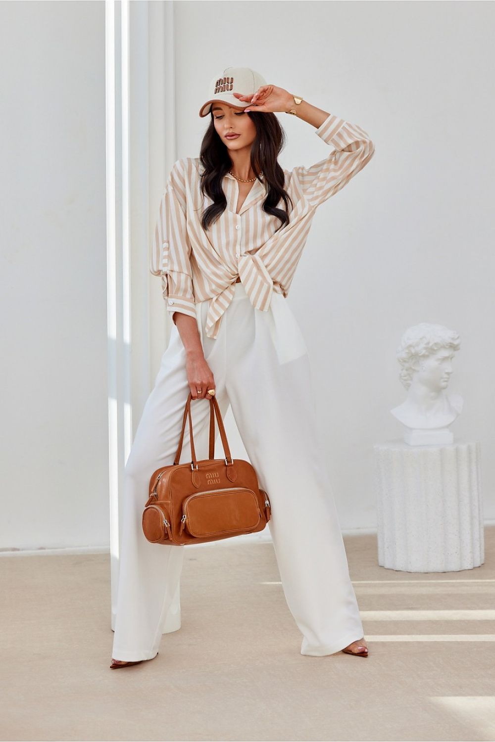 Stylish Roco Fashion oversized shirt draped elegantly on a mannequin, showcasing its beautiful asymmetrical silhouette and decorative buttoned cuffs.