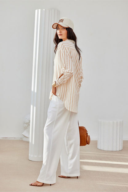 Roco Fashion oversized shirt flat lay, illustrating its fashionable long sleeves and distinctive decorative cuffs, designed for comfort and elegance in EU sizes S/M to L/XL.
