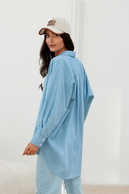 Roco Fashion's oversized long sleeve shirt in an inviting setting, showcasing fashionable versatility in sizes S/M and L/XL.