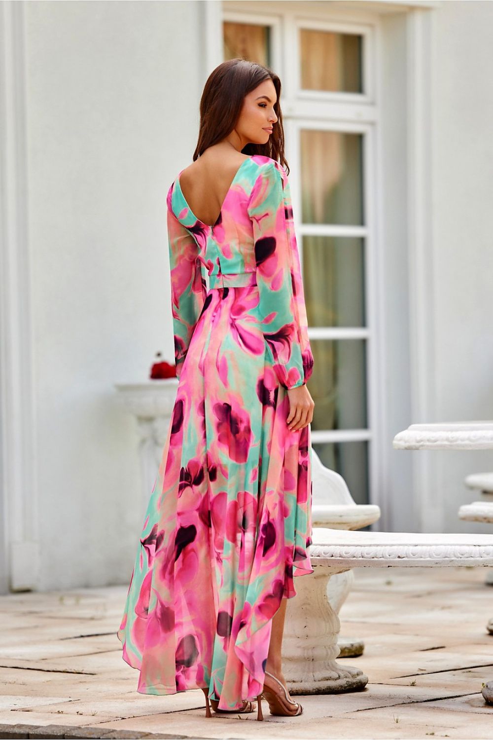 The stunning silhouette of Roco Fashion's asymmetric maxi dress, featuring a fitted waist and flared skirt, ideal for enhancing any figure.