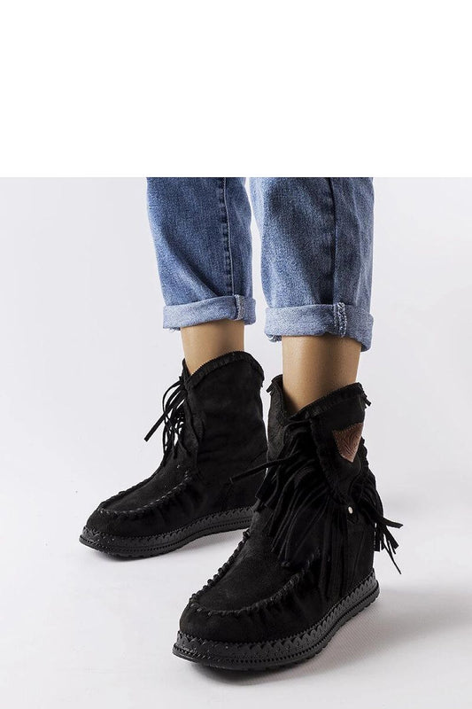 Elegant Solea Black Wedge Boots with high uppers, perfect for pairing with stylish outfits in cooler seasons.