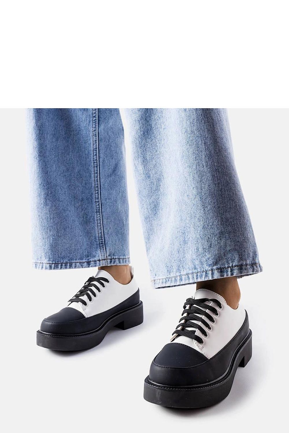 Detail of Solea black summer shoes featuring classic lacing closure, designed for sophisticated style and comfort.