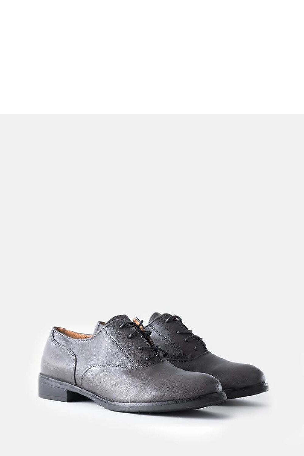 Close-up view of Solea Red Burdett vegan leather loafers, highlighting the luxurious texture and round toe detail.