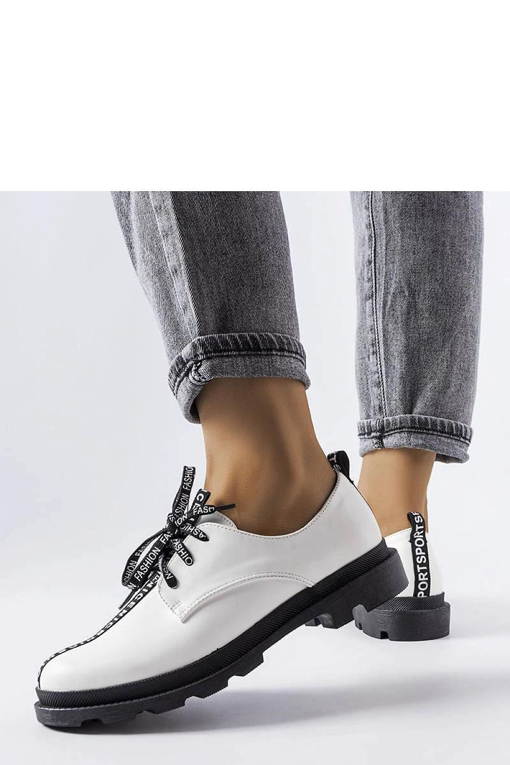 Close-up view of Solea White Hanifan loafers showcasing their elegant square heel and minimalist stitching for a sophisticated look.