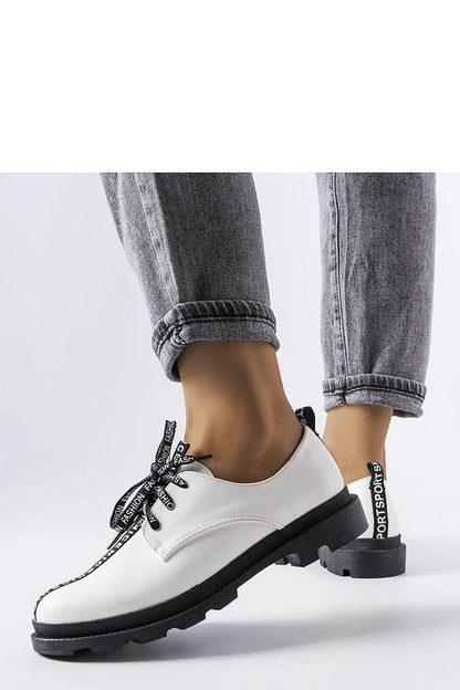 Close-up view of Solea White Hanifan loafers showcasing their elegant square heel and minimalist stitching for a sophisticated look.