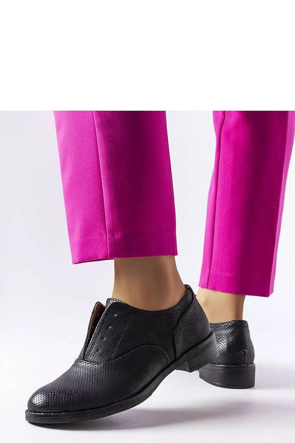 Close-up of Solea black eco-leather half shoes displaying intricate perforated detailing, ideal for sophisticated outfits, featuring a breathable insole for all-day wear.