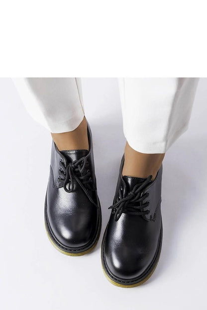 Close-up of Solea Black Parfait shoes, featuring eco-friendly leather and unique yellow soles, combining sophistication and practicality for all-day comfort.