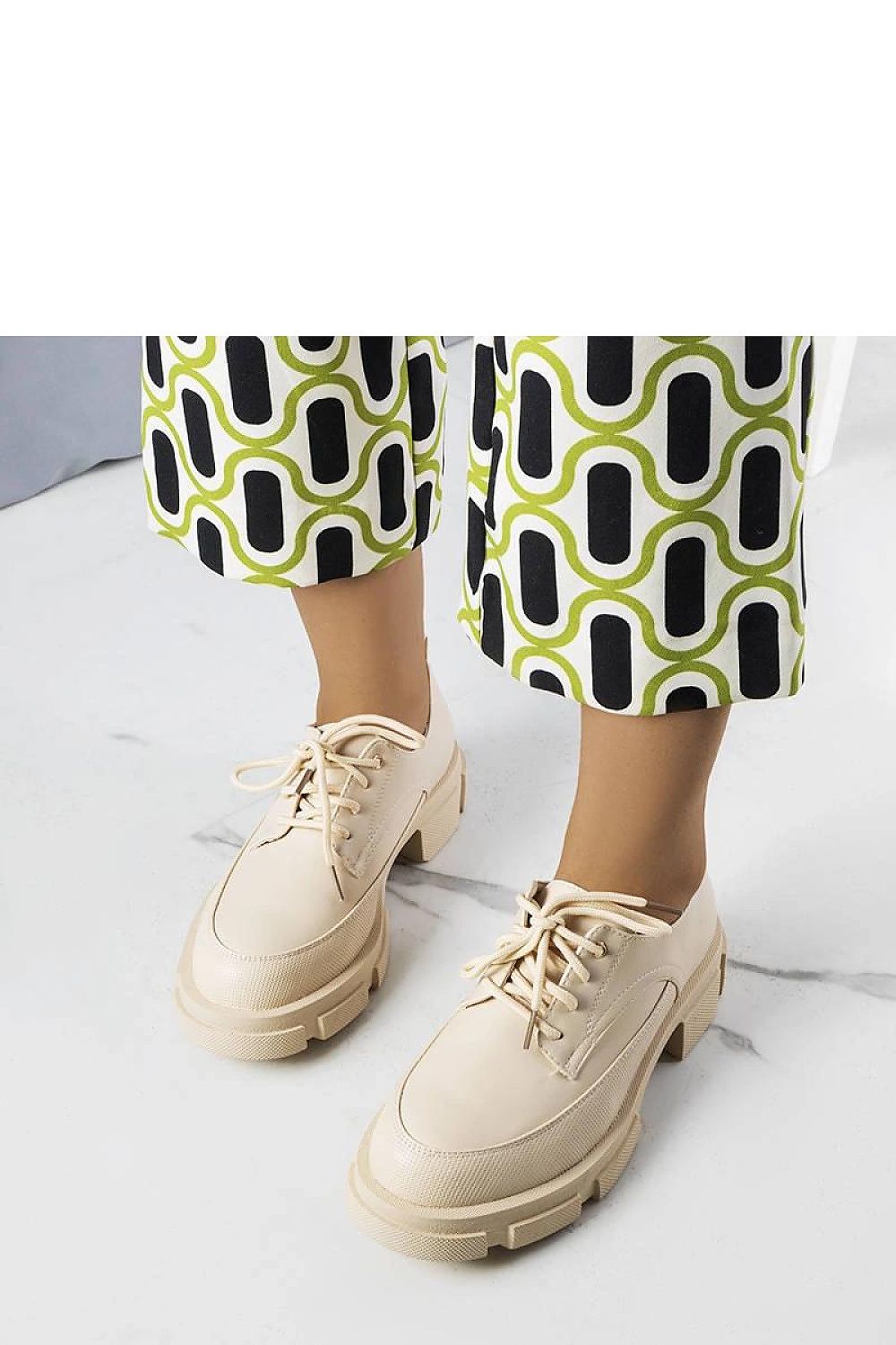 Solea half shoes on a bold white rubber sole, featuring unique short laces and a round toe, designed for fashionable summer styles.