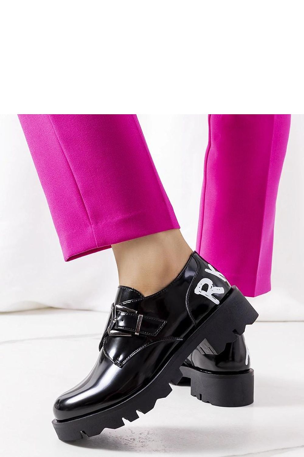 Close-up of Solea black slip-on loafers for women, highlighting the elastic insert and buckle detail offering a perfect fit for refined casual wear.