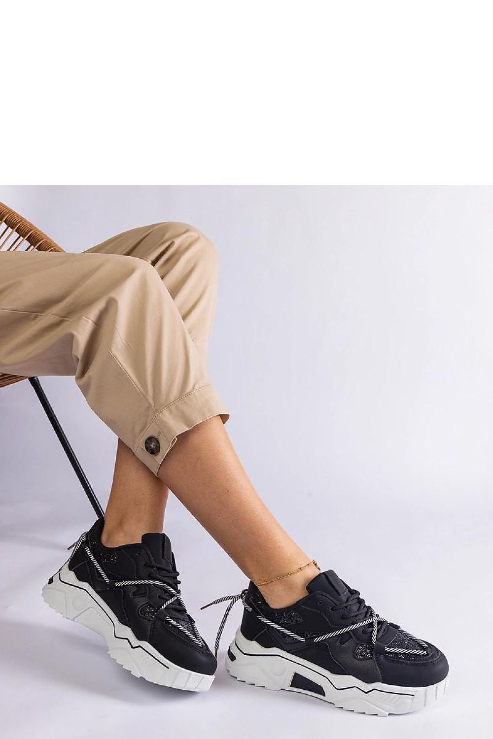 Elegant Solea black sneakers with sophisticated brocade overlay, perfect for elevating any fashionable outfit with their versatile design.