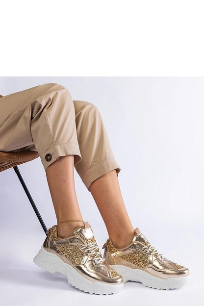 Elegant Solea women's golden sneakers featuring detailed brocade inserts and a lightweight white rubber sole, perfect for casual wear.