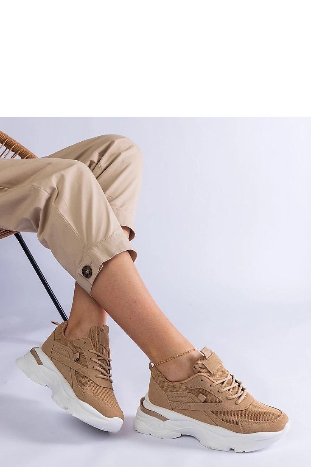 Close-up view of Solea women's sneakers showcasing the premium craftsmanship of the elegant brown synthetic leather and lace-up design.