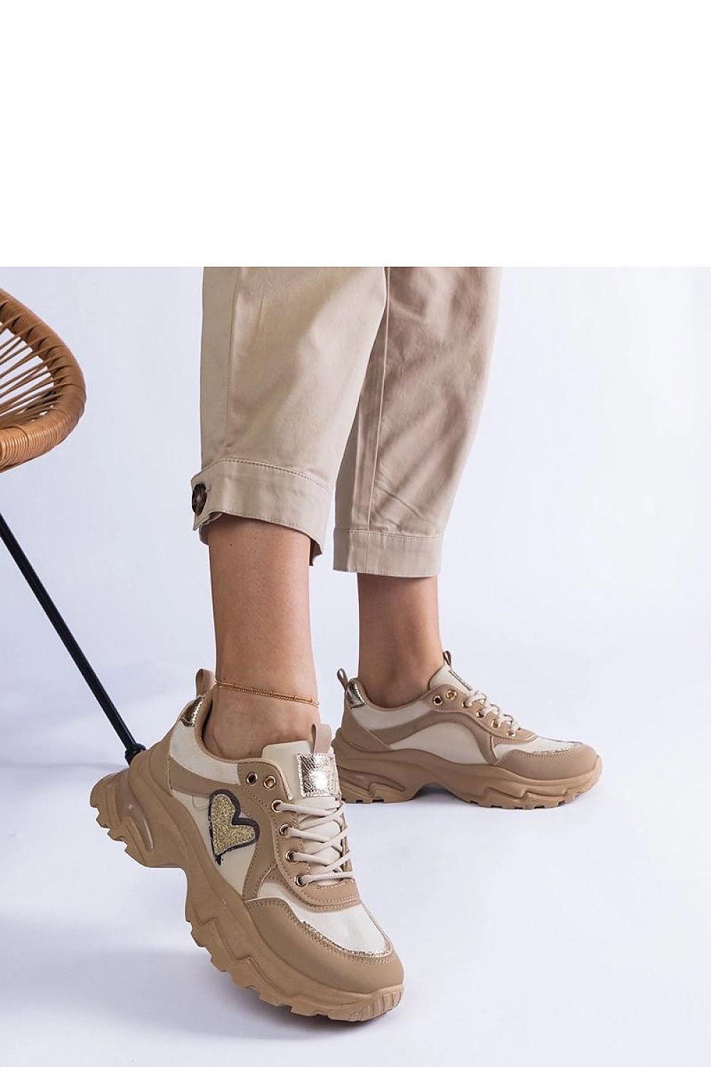 Close-up view of Solea brown platform sneakers showcasing high-quality artificial leather and unique heart detail for a fashionable touch.