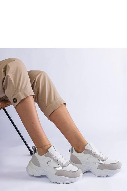 Close-up view of Solea's sleek white sneakers, highlighting the durable Torreza Hurtado rubber sole and stylish low-profile design.