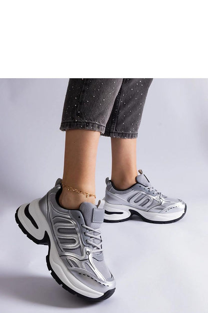 Side view of Solea silver sporty sneakers, featuring a low profile and black rubber sole for a trendy casual look.