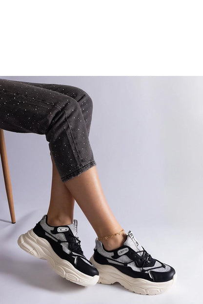 Solea elegant black sneakers featuring intricate brocade inserts, showcasing designer style and luxury craftsmanship.