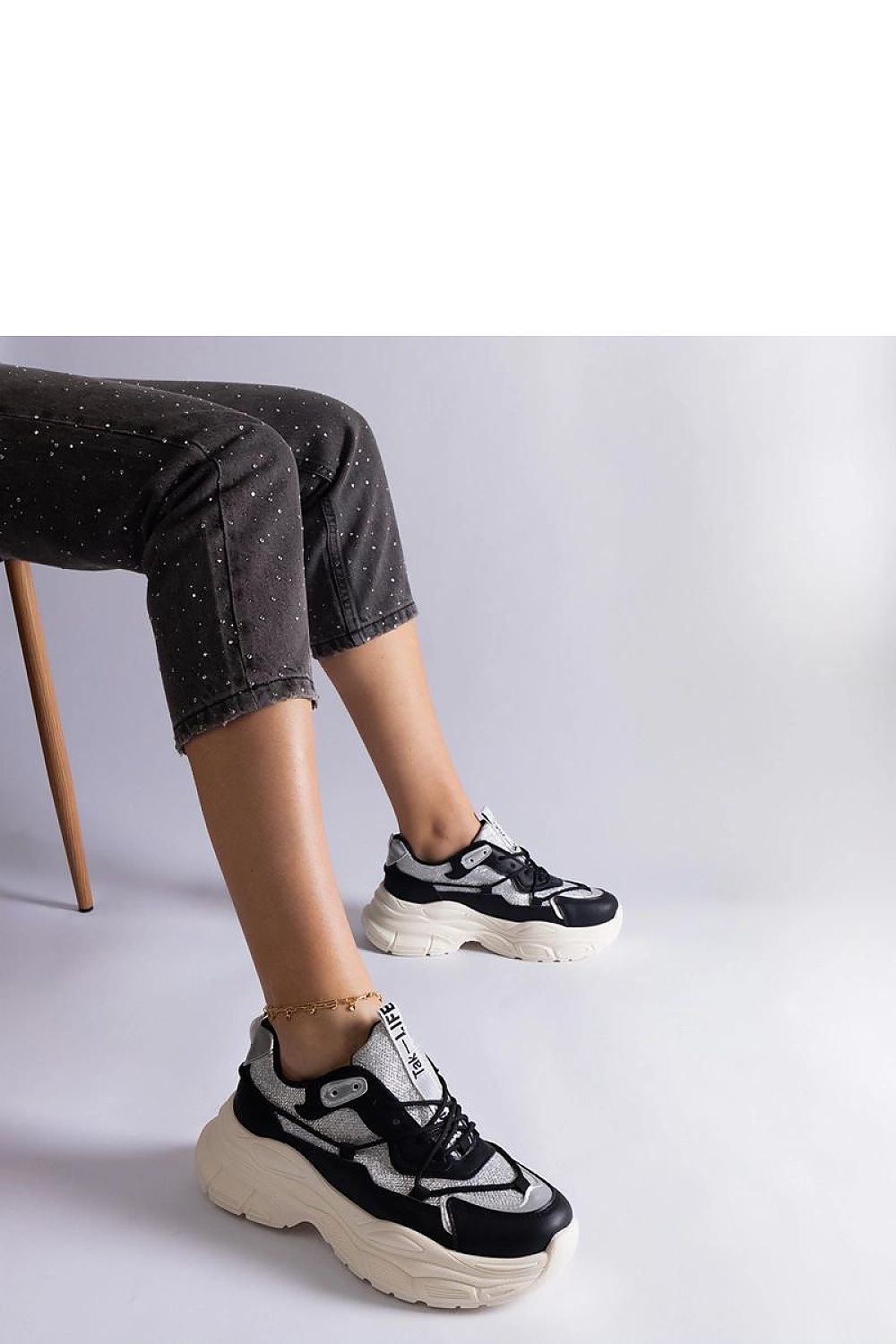 Solea black sneakers poised against a minimalist backdrop, exuding sophistication with a 5cm heel height and durable rubber sole.