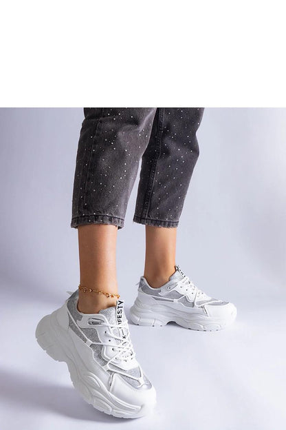 Close-up of Solea black sneakers with intricate brocade details and white rubber sole, highlighting the perfect blend of comfort and sophistication.