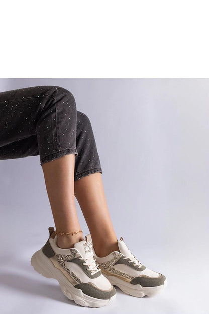 Solea Beige Lace-Up Sneakers in a fashionable setting, showcasing their luxury brocade detail and practical rubber sole.