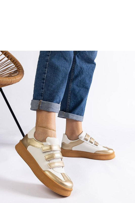 Close-up of Solea luxurious golden sneakers made from eco-leather, highlighting the practical Velcro fastening for everyday wear.