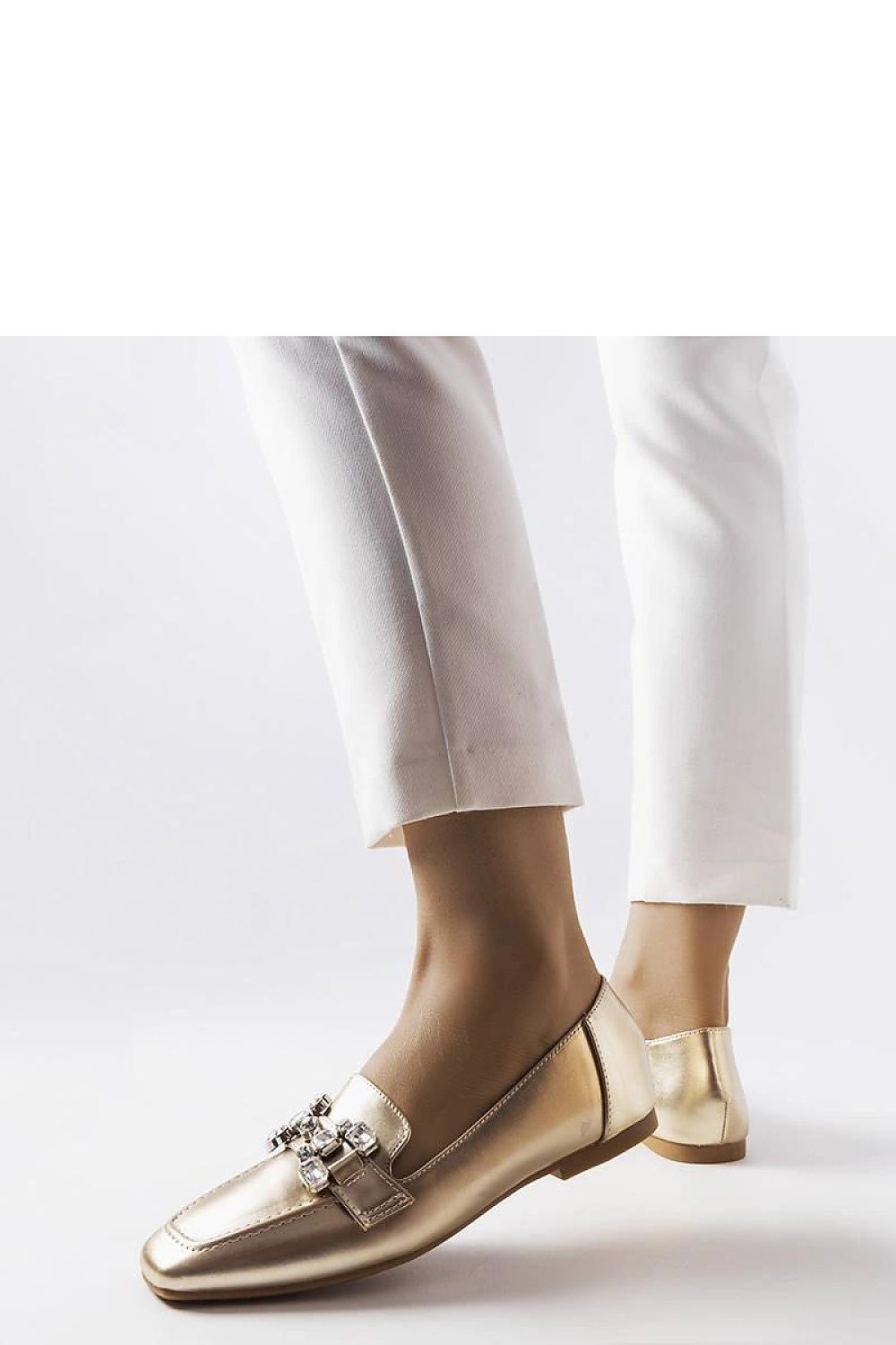 Close-up of Solea gold moccasins showcasing the luxurious eco-leather and sparkling zircons, perfect for a chic summer look.