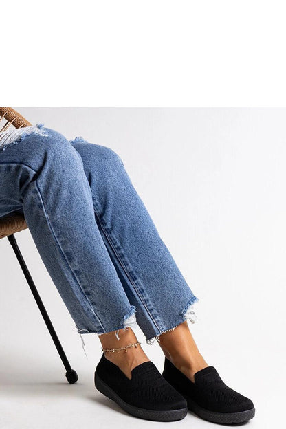 Elegant Solea luxury black slip-on sneakers, designed for summer comfort and style, featuring a chic fabric upper and flexible rubber sole.