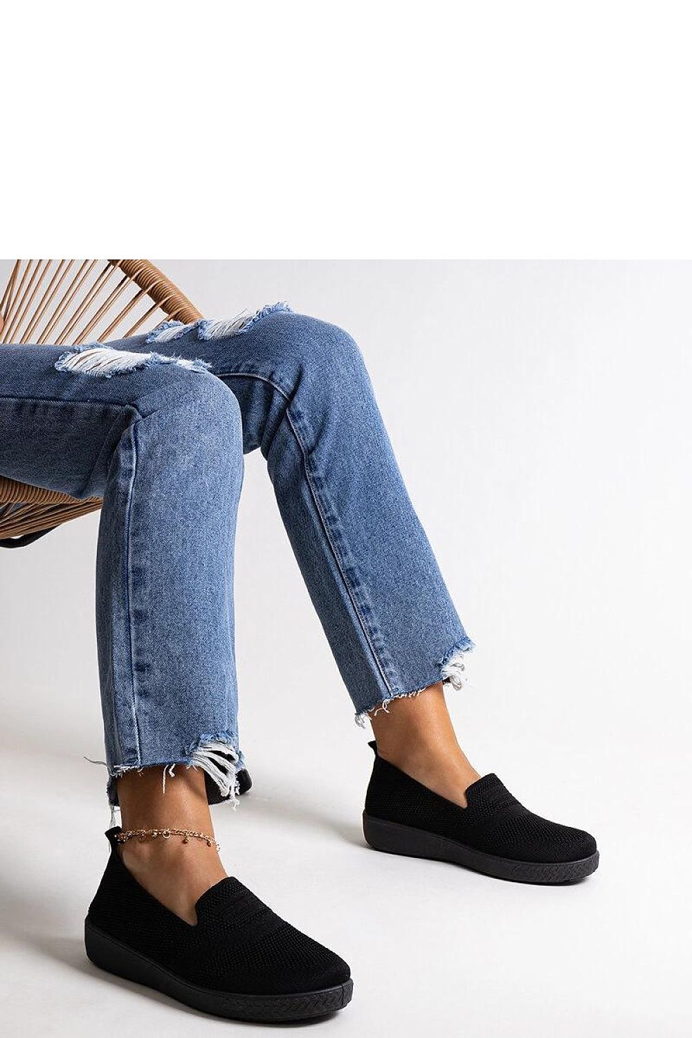 Close-up of Solea luxury black slip-on sneakers, showcasing the durable stitching and sophisticated design ideal for fashionable summer outings.