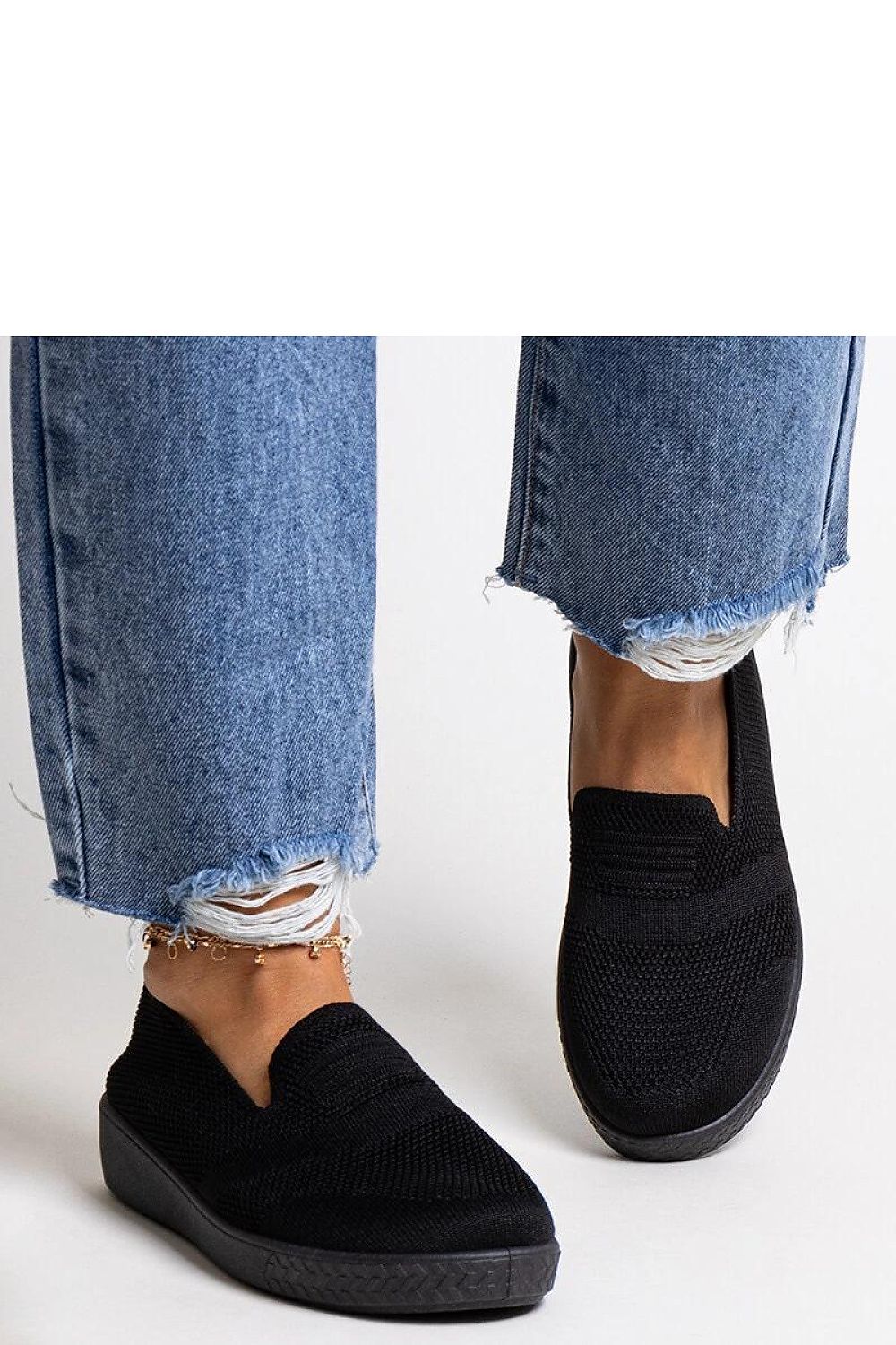 Solea luxury black slip-on sneakers displayed outdoors, exemplifying their versatility and comfort for warm weather occasions.