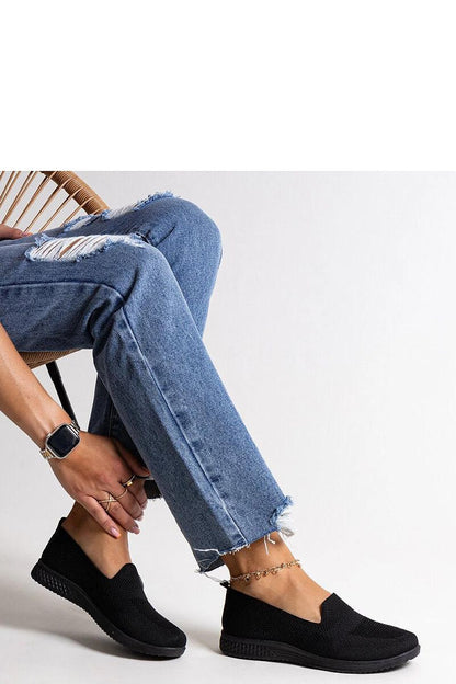 Elegant Solea Black Slip-On Abadly Sneakers for Women on a stylish outdoor setting, showcasing their modern almond toe design and summer fashion appeal.